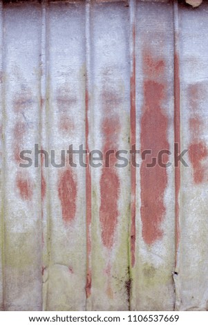 Rustic corrugated metal wall. Old metal fence with red, green and blue color.