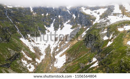 Aerial view of the snow in a canyon high in the Alpine mountains.