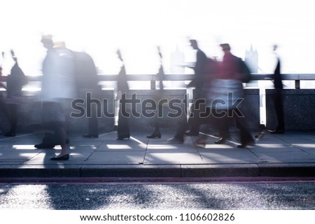 City commuters. High key blurred image of workers on London Bridge. Concept for Londoners, modern life, management, corporate, future cities, employment, digital transformation, business, finance