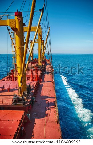 Cargo Ship Sailing in High Sea Royalty-Free Stock Photo #1106606963