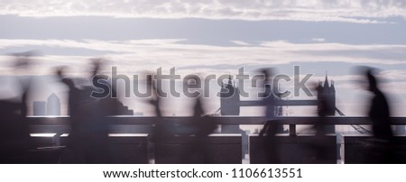 Panoramic view of city commuters. Intentionally blurred image of workers on London Bridge. Unrecognizable faces. London. Concept for Londoners, modern life, management, corporate, finance, business