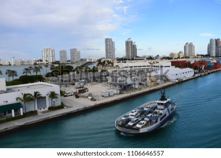 A view of Downtown Miami in the background, and a car ferry in front.