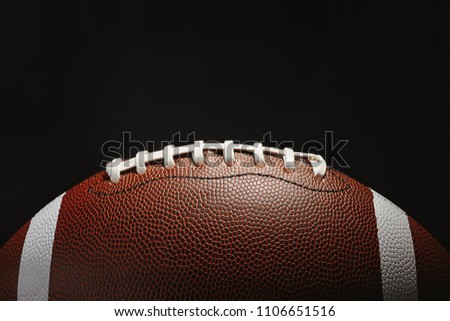 New American football ball on dark background
