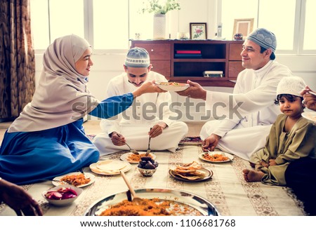 Muslim family having dinner on the floor Royalty-Free Stock Photo #1106681768