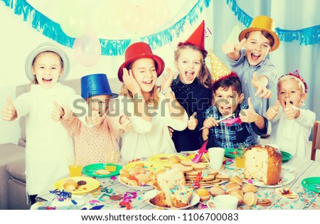 happy spanish children having celebration of friend’s birthday during dinner