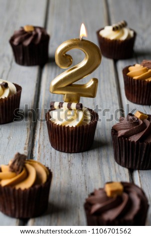 Number 2 celebration birthday cupcakes on a wooden background