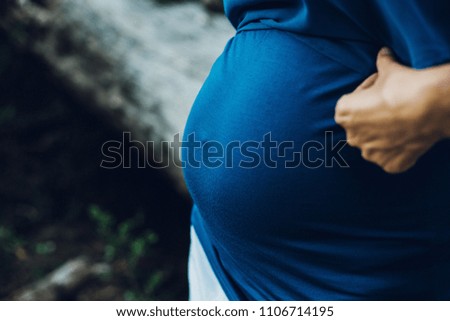 Pictures of the belly of pregnant women in nature with natural background