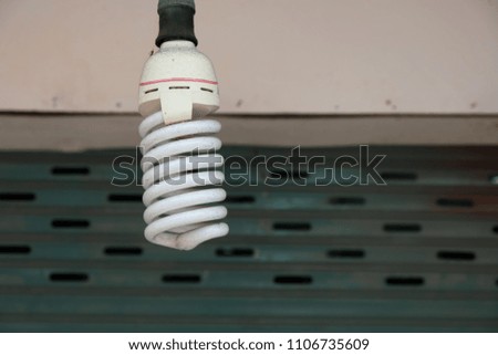 Ordinary lamp hanging on grunge background closeup photo