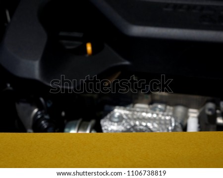 A Product Display Card, Showing a Blurred Car Engine of Various Mechanical Parts.