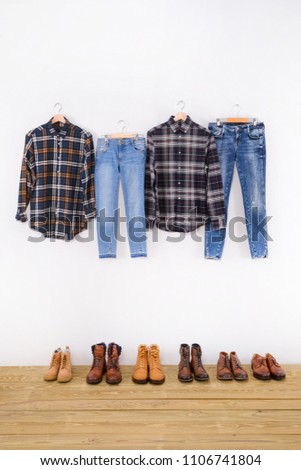 Men's sleeved plaid cotton with blue jeans on hanger ,boots, shoes –wooden background 

