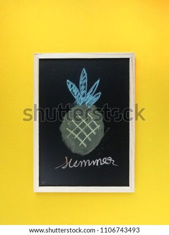 Top view flat lay of sweet pineapple with blackbord for Text space on yellow summer background.