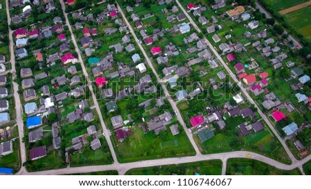 village with lot of houses and cars aerial view