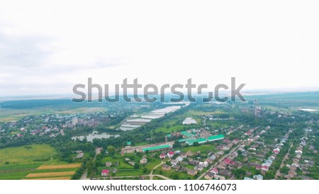 village with lot of houses and cars aerial view