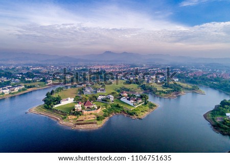Aerial View of Cape, Bay, and Islets Landscape on the Blue Water with Blue Sky, Bandung, West Java, Indonesia, Asia Royalty-Free Stock Photo #1106751635
