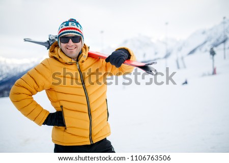 Portrait of smiling man with mountain skis