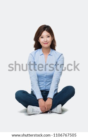 Young Asian woman sitting floor isolated on white.