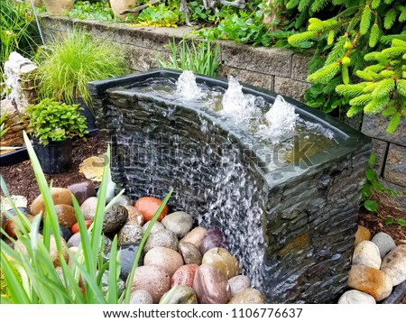 Landscape Design Ideas with Bubbling Water Feature  Royalty-Free Stock Photo #1106776637