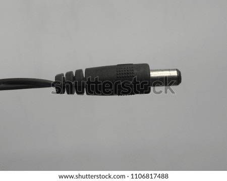 
Black color male jack of power plug adapter on white background
