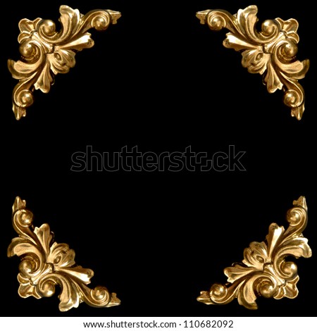 golden elements of carved frame on black background