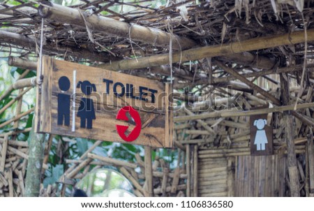 Symbol toilets on the wooden floor,bathroom