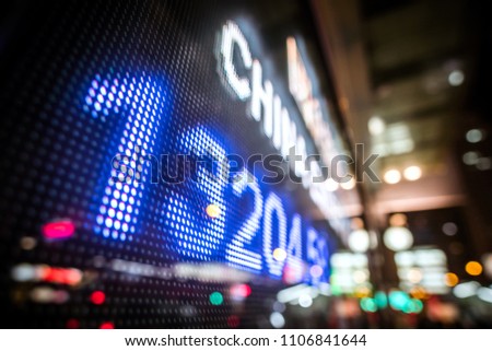 Display of Financial Stock market quotes with city scene reflect on glass