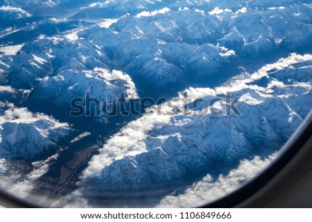 View from Airplane Window of Alps in Europe during Winter
