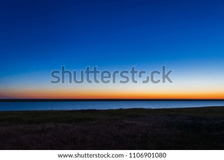 Gradient sunrise sky showing blue, yellow and orange layer