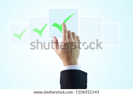 Closeup on a hand of businessman touching digital checkboxes as checklist items isolated on light blue gradient background