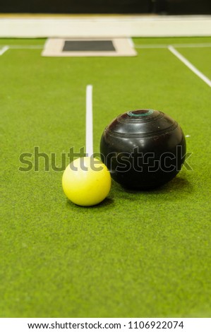 Bowl and jack on an indoor bowls carpet