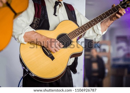 Handsome young men playing guitar