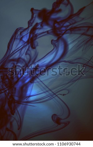 Ink in water. Neon background. Trendy dark wallpaper. Abstract ocean.