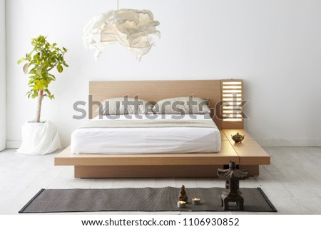 Modern peaceful Bedroom. zen style bedroom. Peaceful and serene bedroom. Wood bed with oriental object.led bed.