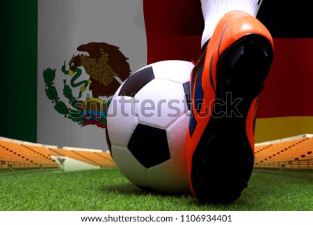 close up legs and feet of soccer player or football player walk on green grass ready to play match on national German and national Mexico.