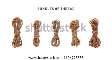 A set of isolated coils of coarse hemp rope.