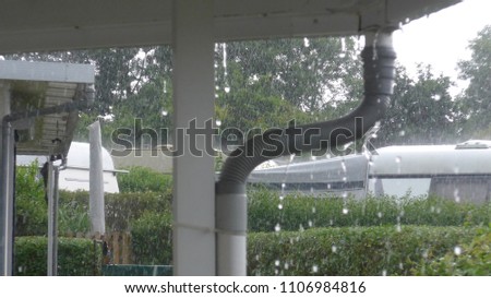 Caravan with a fixed veranda on a German campsite.Detail photo from the rain drain pipe on a very rainy day,