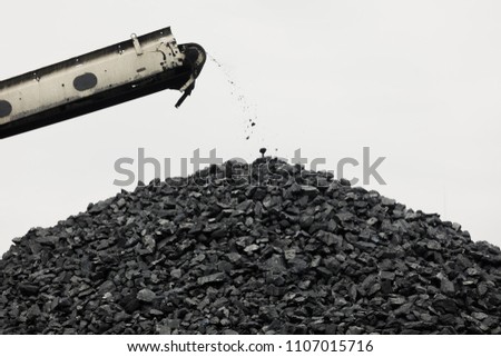 Coal stacker and Coal Reclaimer are mining machinery, or mining equipment in the mining industry that large or huge machine used in bulk material handling in stockpile as the Coal Production. Royalty-Free Stock Photo #1107015716