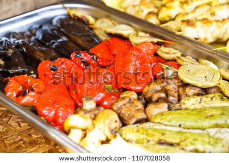 Fried vegetables on the grill with a delicious crust on the background of vegetables. Summer holidays and food in nature. Stock Photo