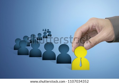 Hand of Male Choose Leader Symbol from Businessman Group with Copy Space and Blue Background, Management and Leadership Concept.