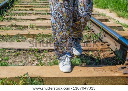 girl walking on wooden railway sleepers home