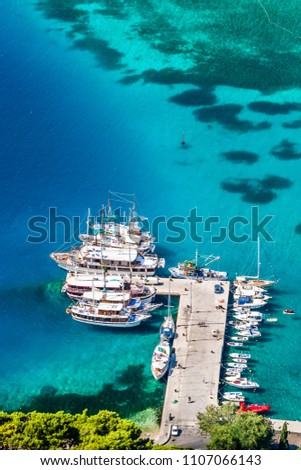 Very beautiful view of the sea and the pier with the boats above Omis. Beautiful sunny day, Dalmatia, Croatia