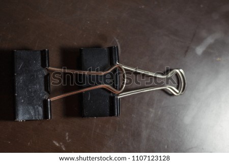 Clips on a brown surface.