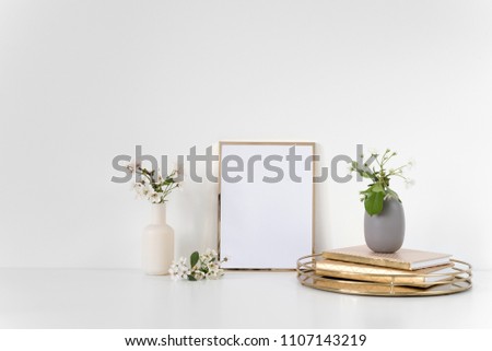 Background for art, photo or text. Gold frame mock up with spring cherry bouquet.