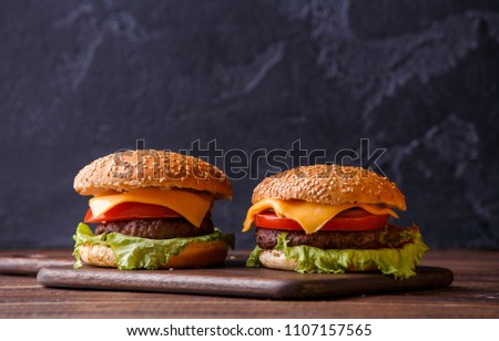 Picture of two hamburgers on wooden table