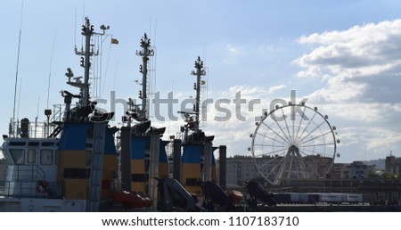 Spain. Malaga. Photo of the Ferris wheel and the ship on the pier