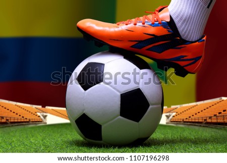 Close up legs and feet of soccer player or football player walk on green grass ready to play match on national Colombia and national Senegal.