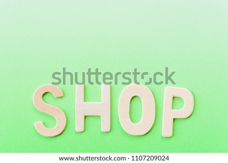 Wooden text type key word of green on green paper background.