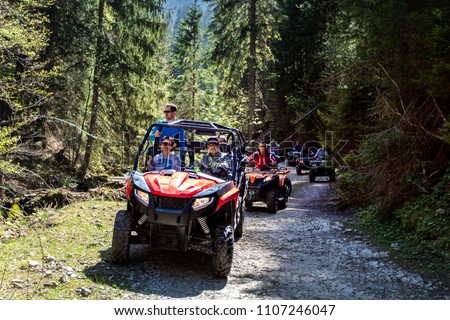 A tour group travels on ATVs and UTVs on the mountains Royalty-Free Stock Photo #1107246047
