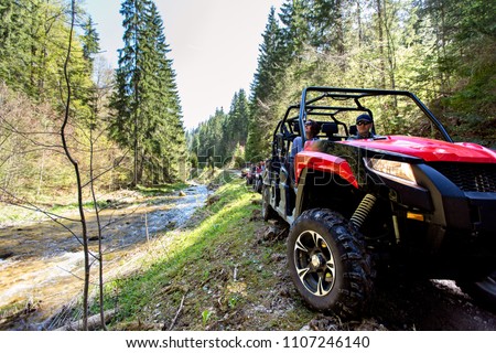 A tour group travels on ATVs and UTVs on the mountains Royalty-Free Stock Photo #1107246140