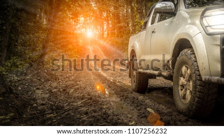 Off-road travel on mountain road, with light off sunset. Royalty-Free Stock Photo #1107256232
