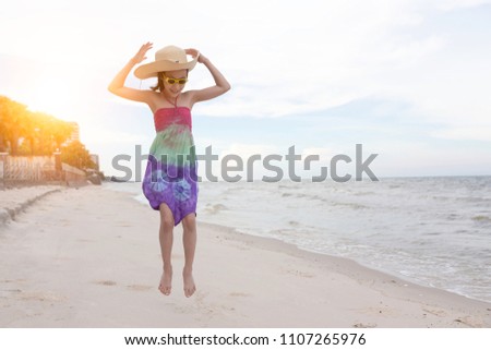 Asian little girl playing on the beach, cute child happy coming to the sea at Hua Hin,Thailand,summertime fun concept